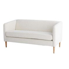 a white couch sitting on top of a wooden table