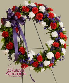 a wreath with red, white and blue flowers