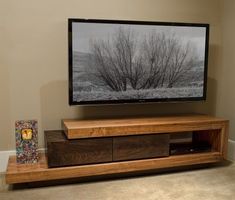 a flat screen tv sitting on top of a wooden entertainment center in a living room