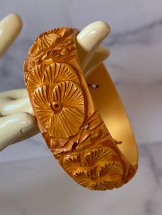 Gorgeous intricately carved and pierced Butterscotch Bakelite Bracelet. Features a carved leaf/foliate pattern and complimentary piercing The bracelet is in very good vintage condition, sold as found. Incredible statement set, true vintage. Standard 2.5 inch opening. One Inch wide width. You will not be disappointed with this beauty, it can hold its own or show up in a Stack! Please contact me if you have specific additional photo requests as photos are part of the description. All items are shi Vintage Carved Orange Jewelry, Orange Carved Vintage Jewelry, Vintage Orange Carved Jewelry, Ornate Carved Bangle Jewelry, Elegant Carved Orange Jewelry, Elegant Orange Carved Jewelry, Antique Carved Bangle For Formal Occasions, Carved Bangle Jewelry For Formal Occasions, Luxury Carved Bangle Bracelet