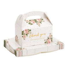 a white box with pink flowers on it and the words thank you in gold lettering