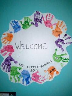 a welcome sign made out of handprints in the shape of a circle