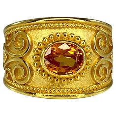 Presenting S.Georgios designer 18 Karat Solid Yellow Gold Ring all handmade with the Byzantine Style workmanship and a unique velvet background decorated with natural oval cut 1.52 Carat Orange Sapphire. All the granulated decorations of this ring are added by hand as well as the unique Byzantine background. This gorgeous piece can be also ordered in all White, or Rose Gold, and with different center stone. please contact us. The ring is outstanding in the quality of workmanship and stone collec Orange Sapphire Ring, Velvet Background, Orange Ring, Bagan, Orange Sapphire, Stone Collection, Yellow Gold Ring, Solid Yellow, Yellow Gold Rings