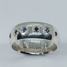 a white gold ring with blue sapphire stones