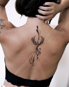 a woman with a tattoo on her back