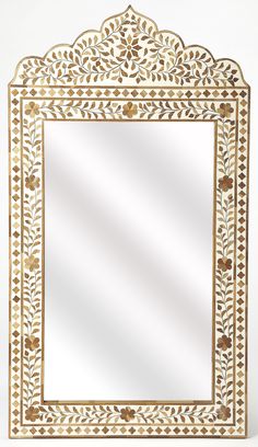 an ornate white and gold mirror on a white background with the reflection of it's own image