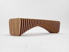 a wooden bench made out of strips of wood sitting on top of a white floor