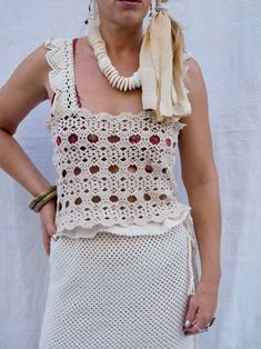 Upcycled Vintage 1970s Crochet Top – Handmade by Vagabond Ibiza This beautiful upcycled crochet top, made from vintage 1970s cotton and silk threads, is a unique and timeless piece. Handcrafted in our Vagabond Ibiza studio, the top showcases exquisite handmade detailing with intricate crochet patterns that have been carefully patchworked together. The delicate craftsmanship and vintage materials make this top both elegant and versatile. With a slim fit designed for small sizes, the top is perfect for layering or wearing on its own for a bold boho look. The model, wearing a UK size 8-10, demonstrates how the top provides a flattering fit. • Material: Vintage 1970s cotton and silk crochet • Size: Small (Model is UK size 8-10) • Design: Patchwork crochet design with intricate detailing • Deta Upcycled Crochet, 1970s Crochet, Silk Crochet, Patchwork Crochet, Bold Boho, Indian Sari Dress, Intricate Crochet, Crochet Size, Kimono Sweater