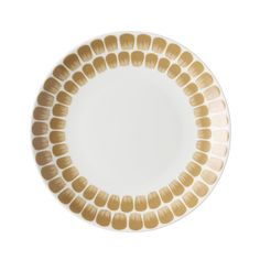 a white and gold plate with small circles on the rim, against a white background