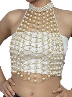 This pearl top is a striking and elegant statement piece designed to elevate any outfit with its luxurious and intricate detailing. The top features a delicate halter-neck design adorned with multiple layers of gleaming faux pearls intricately connected by gold-toned chains, creating a webbed, grid-like structure across the front. The high neckline, fully encrusted with pearls, adds a touch of sophistication, while the cascading pearls arranged in horizontal rows enhance the regal aesthetic. The Elegant Sleeveless Crop Top For Wedding, Elegant Embellished Wedding Crop Top, Elegant White Crop Top For Wedding, Elegant White Party Crop Top, Elegant White Crop Top For Party, Elegant Festive Evening Crop Top, Elegant Festive Crop Top For Wedding, Elegant Fitted Crop Top For Festive Occasions, Fitted Elegant Crop Top For Festivals