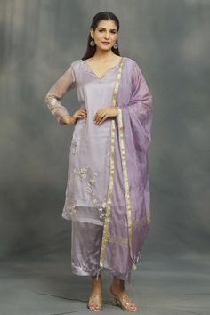 Lilac kurta with aari, sequin, thread embroidery in floral placement pattern. Paired with pant and dupatta.
Components: 3
Pattern: Embroidery
Type Of Work: Aari, sequin, thread
Neckline: V neck
Sleeve Type: Long sleeves
Fabric: Kurta: Organza, Pant: Satin, Dupatta: Chiffon
Color: Purple
Other Details: 
Fringe tassel bordered dupatta
Occasion: Sangeet - Aza Fashions Festive Straight Kurta In Tissue Silk, Straight Kurta With Dupatta In Tissue Silk, Festive Cotton Silk Palazzo Set With Cutdana, Festive Cotton Silk Palazzo Set With Gota Work, Slub Silk Traditional Wear With Dupatta For Eid, Festive Cotton Silk Palazzo Set With Dupatta, Resham Embroidered Churidar For Wedding, Purple Chanderi Palazzo Set With Sheer Dupatta, Eid Slub Silk Traditional Wear With Dupatta