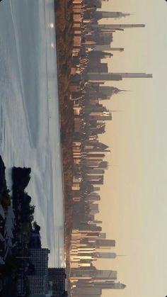 an aerial view of a city with tall buildings in the foreground and snow on the ground