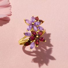 Ross-Simons - 1.40ct t. w. Rhodolite Garnet, 1.20ct t. w. Amethyst, .50ct t. w. Garnet Flower Ring Over Sterling. Size 8. An RS exclusive. Just like a fresh bouquet of flowers from the farmer's market, this ring will brighten your day! The pretty florals feature 1.40 ct. t. w. rhodolite garnets, 1.20 ct. t. w. amethysts and .50 ct. t. w. garnets in polished 18kt yellow gold over sterling silver. 1" wide. Garnet, amethyst and rhodolite garnet flower ring. Garnet birthstones are the perfect gift f Flower Ring Design, Amethyst And Garnet, Garnet Birthstone, Pretty Rocks, Tanzanite Ring, Ruby Jewelry, Rhodolite Garnet, Bouquet Of Flowers, Farmer's Market