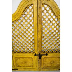 an old yellow wooden door with intricate carvings