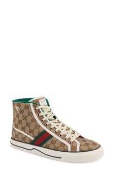 Heritage details re-emerge to style a pre-fall 2020 sneaker that sports a dedicated Tennis 1977 label and racing stripes of house webbing on GG Supreme canvas. Style Name:Gucci Tennis 1977 High Top Sneaker (Men). Style Number: 6081059. Available in stores. Gucci Lace-up Sneakers With Logo Detail, High-top Custom Sneakers With Logo For Streetwear, Custom High-top Sneakers For Streetwear With Logo, Gucci Sneakers With Logo Detail For Sports, Gucci Custom Sneakers With Rubber Sole For Streetwear, Gucci High-top Lace-up Sneakers With Logo, Gucci Sneakers For Sports With Laces, Gucci Sneakers With Laces For Sports, Gucci Lace-up High-top Sneakers With Logo Detail