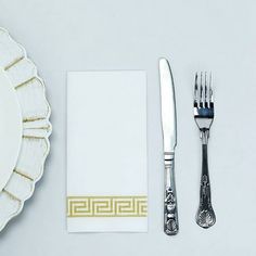 a place setting with silverware and napkins