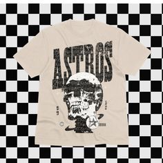 The ONLY Astros shirt you need in your life.  Oversized print on ALL sizes. Get matching tees for the whole family or just for yourself. Sizes from 3-6 month up to 3X. Cotton Grunge T-shirt With Skull Print, Graphic Tee Shirt For Fan Gear, Skull Graphic Tee With Text Print, Relaxed Fit Skull Print Shirt For Streetwear, Cotton Graphic Print Shirt For Fan Merchandise, Cotton Graphic Print Shirt For Fans, Pop Culture Cotton Shirt With Graphic Print, Graphic Tee With Skull Print For Streetwear, Cotton Pop Culture Shirt With Graphic Print