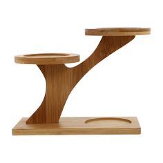 a wooden table with a circular base and two trays on each side that are shaped like a tree