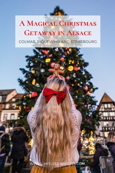 a woman with long blonde hair wearing a red bow tie and looking at a christmas tree