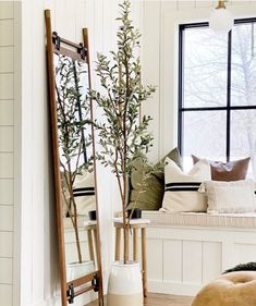 a living room with white walls and wooden flooring next to a window sill