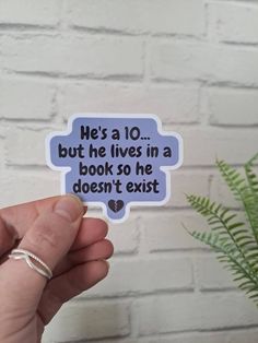 someone holding up a sticker that says he's a 10 but he lives in a book so he doesn't exit