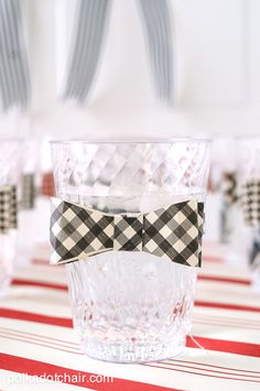 a bow tie sitting on top of a glass