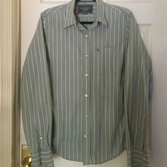 This Is A Beautiful Pale Green Button Down Shirt With Navy And Cream Stripes. Chest Pocket With The Moose Symbol, And Long Sleeves With Two Buttons. Never Worn. Green Casual Button-up Dress Shirt, Casual Green Button-up Dress Shirt, Fitted Casual Cotton Blouse, Striped Buttoned Shirt For Business Casual, Business Casual Striped Shirt With Buttons, Casual Striped Button-up Dress Shirt, Semi-formal Striped Button-up Shirt, Green Semi-formal Button-up Shirt, Striped Button-up Top For Semi-formal Occasions