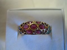 This ring contains 7 Rubies in a flower design in the center with 5 Emeralds on each side. The pierced work sets off the beauty of the ring. All stones are in good shape. The ring is in excellent condition. All stones are natural! The ring is a size 6. There are no markings on the ring. It tests 14K for sure or possibly higher. Thank you for viewing. Free Shipping USA Antique Oval Multi-stone Ring, Antique Multi-stone Round Emerald Ring, Antique Multi-stone Yellow Gold Cluster Ring, Antique Round Multi-stone Emerald Ring, Antique Multi-stone Cluster Ring In Yellow Gold, Vintage Multi-stone Gemstones For Wedding, Antique Multi-stone Cluster Ring, Vintage Ruby Multi-stone Cluster Ring, Vintage Multi-stone Ruby Cluster Ring