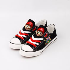 a pair of black and red sneakers with mario on them