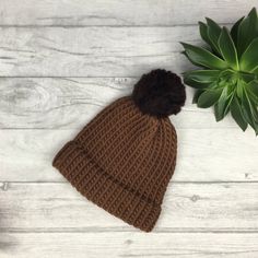 Our tonal brown knitted hat is made from 100% merino wool which is known for being super soft, warm and long lasting.  We choose wool as it is so durable and a natural product. At the end of its life, it is biodegradable.  We believe in beautiful, practical and long lasting items which are unique, a joy to own and will be treasured for many years to come.  - Chocolate and Hazelnut brown  - Designed to fit snug to your head - 100% wool  - Available with or without a pom pom  - Pom pom (if requested) will be in hazelnut brown  - Gift wrapped  || Sizes || Tiny baby - From birth, this is suitable for smaller and premature newborn babies.  0-3 months - From birth to 3 months old  3-6 months - From approximately 3 months old to 6 months and beyond 6 months - 12 months - This hat will adapt to yo Classic Knitted Beanie For Fall, Classic Knitted Merino Wool Beanie, Classic Knit Beanie Hat, Cold Weather Solid Knitted Beanie, Classic Warm Wool Hat, Classic Knitted Beanie For Cold Weather, Solid Knit Beanie Hat, Wool Crochet Hat For Winter, Solid Warm Wool Beanie