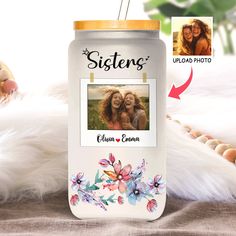 a white can with an image of two women on it next to some feathers and eggs