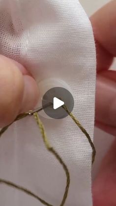 someone is stitching together some thread with their thumbnails to make it easier for them to sew