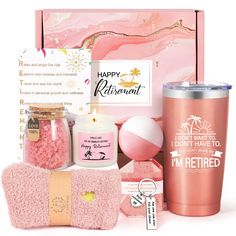 a pink gift box with items from the brand happy retirement on it, including a travel mug, towel, and bath mitt