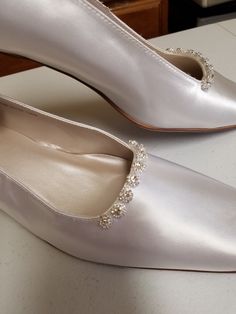 "Beautiful elegant pump style shoes, for the minimalist bride who loves chic shoes! HEEL square, as shown in white: 1 1/2\" If, you prefer the champagne pictured heels (up to size 12, 12W) please click on link below: www.etsy.com/listing/703287418/gold-pump-shoesgolden-anniversary? Please look at the pictures for details such as the gold tone bling brooches adding a very special Elegant & Chic touch. COLOR AVAILABLE: Champagne, Silver, White, Off-White, Ivory SIZES AVAILABLE: M (Medium width Classic Cream Closed Toe Wedding Shoes, Classic Round Toe Wedding Court Shoes, Classic Wedding Court Shoes With Round Toe, Classic Cream Almond Toe Wedding Shoes, Classic Closed Toe Wedding Court Shoes, Classic Closed Toe Court Shoes For Wedding, Classic Pointed Toe Kitten Heels For Wedding, Classic Kitten Heels With Pointed Toe For Wedding, Classic Flat Heel Wedding Shoes