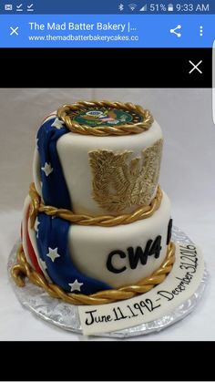 a three tiered cake decorated with flags and gold