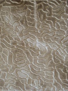 a close up view of the textured fabric on a bed sheet that has been made to look like an abstract pattern