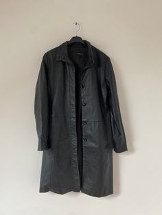 This vintage black leather coat is a stunning piece that exudes elegance and sophistication. The coat is made from high-quality leather in black, which gives it a classic and timeless look. 100% genuine leather. Measurements: Length:  Chest:  Hip:  Arm length from shoulders:  Beautiful vintage condition. Some signs of wear, 10/8. This item will be shipped by DHL EXPRESS to the USA and non-European countries. Inside the European Union I work with several courier companies. Model is 174cm and her Elegant Black Leather Long Coat, Vintage Black Leather Winter Outerwear, Vintage Black Leather Outerwear For Winter, Vintage Black Leather Outerwear For Fall, Classic Vintage Black Outerwear For Fall, Vintage Black Leather Jacket For Work, Vintage Black Leather Jacket For Office, Long Leather Trench Coat, Long Leather Jacket