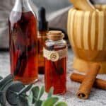 some bottles and cinnamons on a table