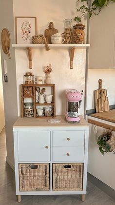 a kitchen area with shelves and baskets on the wall