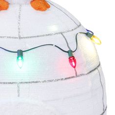 christmas lights are attached to the top of a large white dome with snow on it