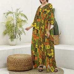 Step into a tapestry of culture with our African Essence Kaftan, adorned with a Mud Cloth-inspired print that weaves a story of African artistry. The warm earthy tones of burnt orange, deep black, and hints of green and yellow capture the spirit of the continent's rich palette, reflecting the beauty of African landscapes and sunsets. Crafted from a sumptuous imitation silk fabric, this kaftan boasts a comfortable yet elegant V-neck design and flows effortlessly over the body in a regular fit, ho Traditional Printed Patterned Maxi Dress, Traditional Patterned Printed Maxi Dress, Bohemian Graphic Print Maxi Dress, Multicolor Long Sleeve Block Print Kaftan, Traditional Printed Patterned Kaftan, Traditional Patterned Printed Kaftan, Bohemian Dresses With Graphic Print, Bohemian Maxi Dress With Geometric Pattern, Yellow Printed Long Sleeve Kaftan