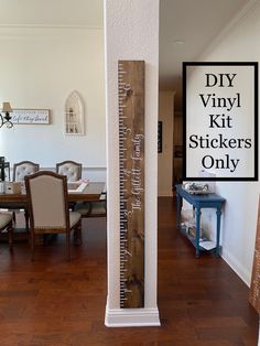 a tall wooden ruler sitting on top of a hard wood floor next to a dining room table