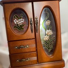 an ornate wooden cabinet with flowers painted on it