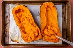 two halves of a sweet potato sitting on top of a pan