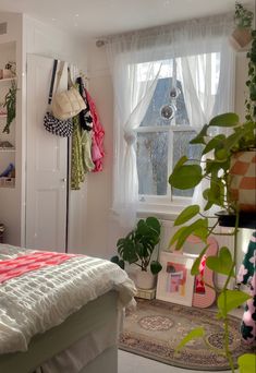 a bedroom with white walls and lots of plants