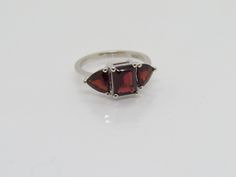 Vintage Sterling Silver 4.00ct Natural Garnet Three stones Ring ...Marked 925...Total of weights 3.2grams...Size 8...With 01 Octagon Garnet 8 x 6MM ( 2.60ct ) And 02 Trillion cut Garnet 6MM ( 1.4ct ) It's in very good condition. A#03 #13 Classic Stone Rings For Formal Occasions, Formal Garnet Three-stone Rings, Classic Rings With Stones For Formal Occasions, Classic Formal Rings With Stones, Formal Three-stone Garnet Rings, Formal Three Stone Garnet Rings, Formal Three Stone Garnet Jewelry, Garnet Rings, Three Stone Rings