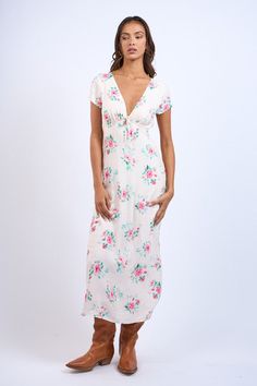 Discover effortless charm with our Floral V-Neck Front Tie SS Midi Dress. Featuring a delicate floral print and a modern v-neck with tie detail, this dress is both stylish and comfortable. With its short sleeves and back zipper, it's easy to slip on and off. Perfect for any occasion, the straight long midi dress is a must-have addition to your wardrobe. Material: 100% Rayon / Lining: 100% Polyester Chic Floral Print V-neck Dress For Brunch, V-neck Midi Dress With Ditsy Floral Print For Summer, Ditsy Floral Print V-neck Dress For Garden Party, Feminine Rayon V-neck Midi Dress, Spring Floral Print V-neck Dress For Vacation, Floral Print V-neck Dress For Summer Brunch, Chic V-neck Dress With Notched Neckline And Floral Print, Spring Rayon V-neck Dress With Short Sleeves, Spring V-neck Dress With Short Sleeves In Rayon