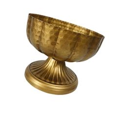 a golden bowl sitting on top of a metal stand