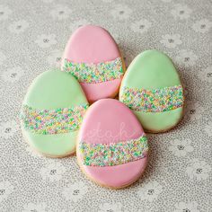 four decorated cookies sitting on top of a table