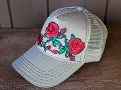 Get ready to party on Derby Day with our Run for the Roses Trucker Hat! Featuring a bouquet of roses, this hat is perfect for any horse racing fan. So put on your party hat (literally) and get ready to celebrate in style. The hat body is a great quality as the front panels and bill are a canvas twill. The back panels are a soft tea stained mesh and has a Velcro closure. One size fits most. Spring Rodeo Cap Hat, Spring Rodeo Snapback Hat, Spring Snapback Hat For Rodeo, Snapback Hats For Country Events In Spring, Spring Snapback Hats For Country Events, Spring Party Trucker Hat With Curved Brim, Spring Party Trucker Hat One Size, Spring Party Trucker Hat, Spring Country Style Baseball Cap